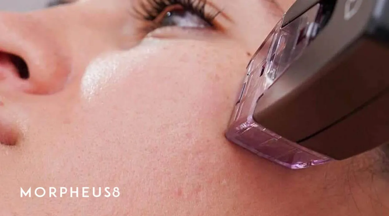 Treatment tip pressed against the cheek of a woman looking upward